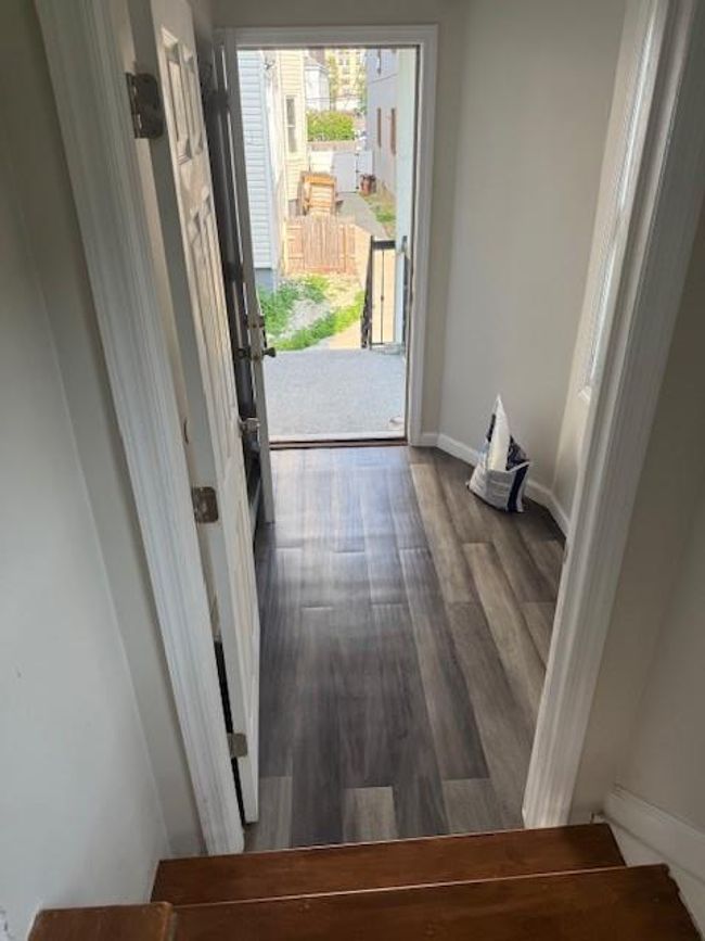 Doorway with dark wood-style flooring and baseboards | Image 17