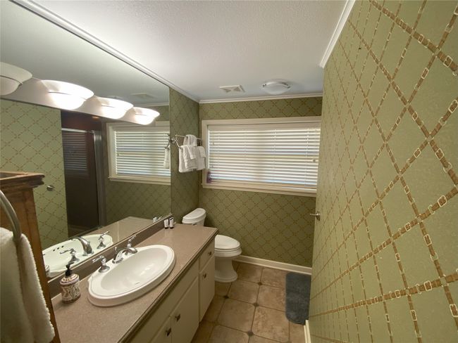 Full bath featuring toilet, vanity, and shower | Image 14