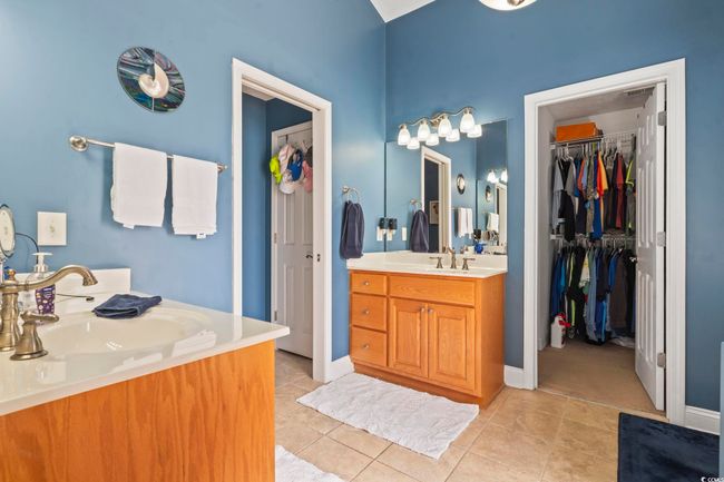 Full bath with two vanities, tile patterned flooring, and a spacious closet | Image 21