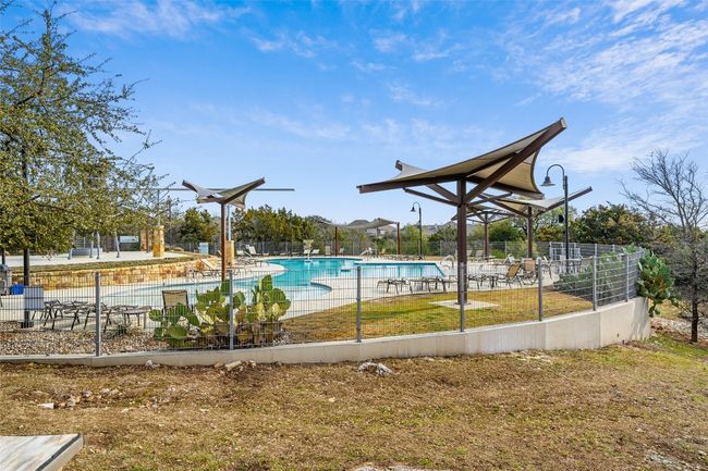 Community pool with a patio area | Image 36