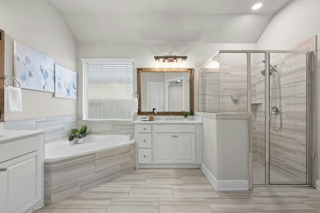 Relax and unwind in the luxurious soaking tub or enjoy the separate walk-in shower with elegant tile accents. | Image 19