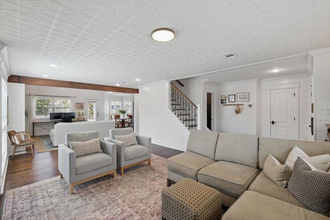 Living area with stairs, wood finished floors, recessed lighting, and an ornate ceiling | Image 5