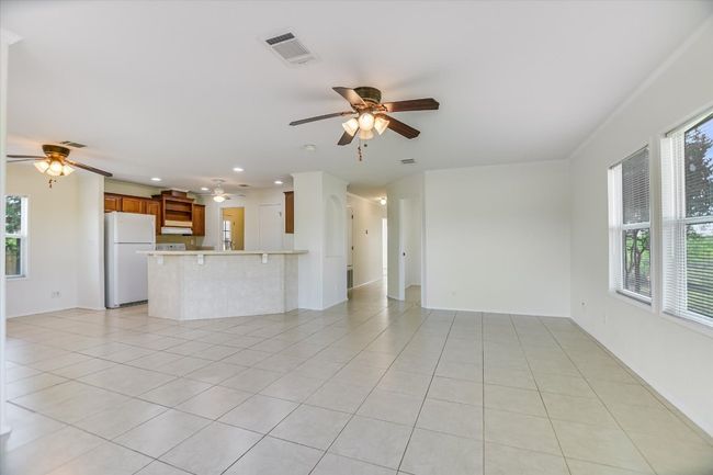 Living room with tile floors, and ceiling fan | Image 9