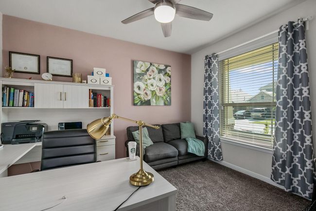 Living room featuring carpet flooring, ceiling fan, plenty of natural light, and baseboards | Image 4