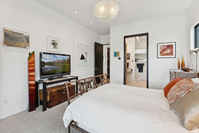 Bedroom featuring light carpet and connected bathroom | Image 33