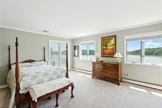 Carpeted bedroom featuring baseboard heating, ornamental molding, and access to exterior | Image 33