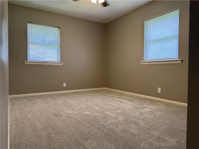 Unfurnished room with carpet flooring and ceiling fan | Image 11
