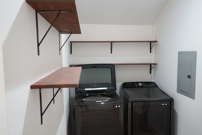 Laundry room with electric panel and washing machine and clothes dryer | Image 14