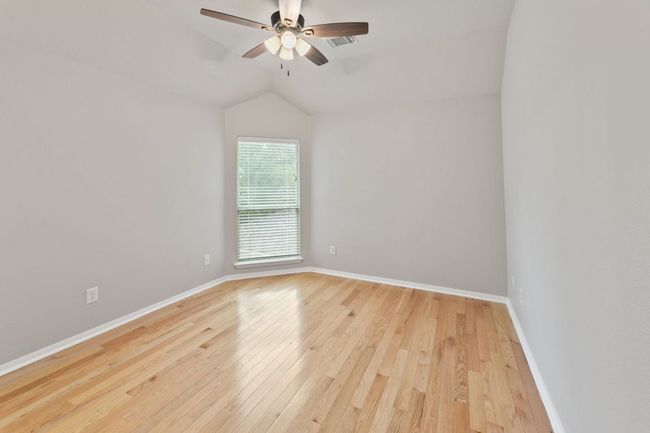 Spare room with ceiling fan, light wood-style floors, and vaulted ceiling | Image 27