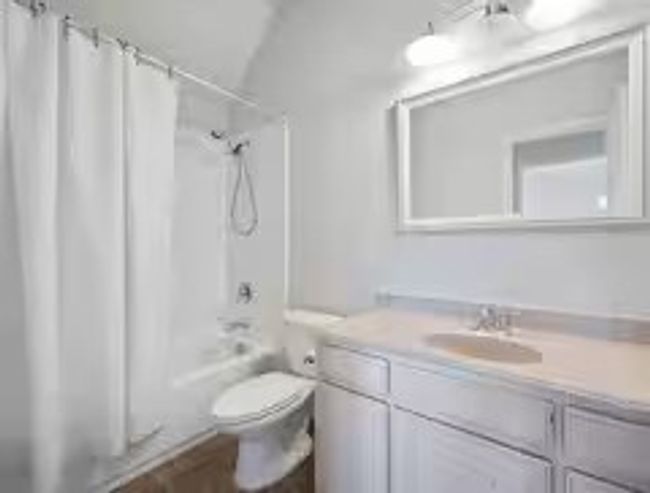 Full bath with vanity, shower / bathtub combination with curtain, and wood finished floors | Image 16
