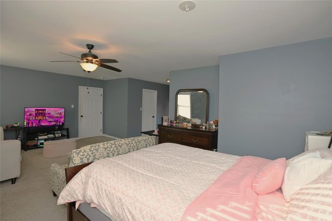 Carpeted bedroom featuring ceiling fan | Image 12