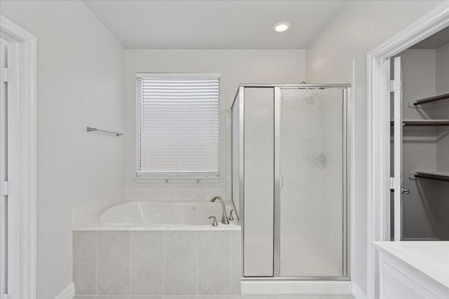 Primary Bathroom featuring a separate shower and jetted tub | Image 19