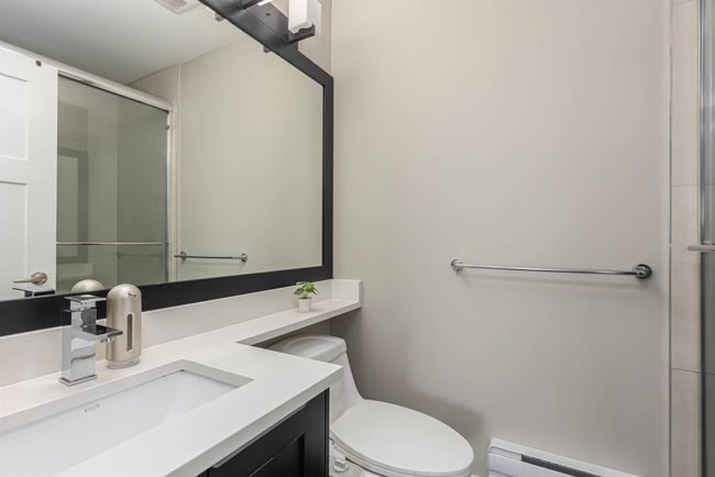 Full bath with baseboard heating, a shower stall, toilet, and vanity | Image 22