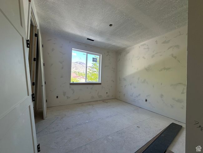 Unfurnished room with a textured ceiling | Image 16