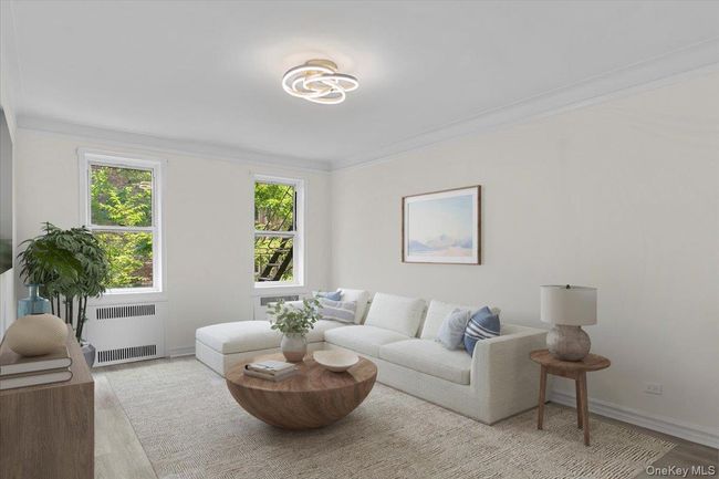 Living room featuring wood finished floors, ornamental molding, and radiator | Image 4