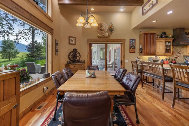 Dining area featuring light wood-style flooring, a chandelier, recessed lighting, and beam ceiling | Image 18