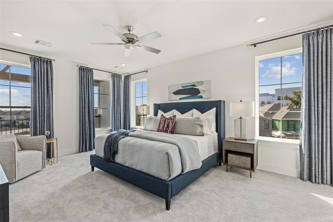 Carpeted bedroom with ceiling fan and multiple windows | Image 22
