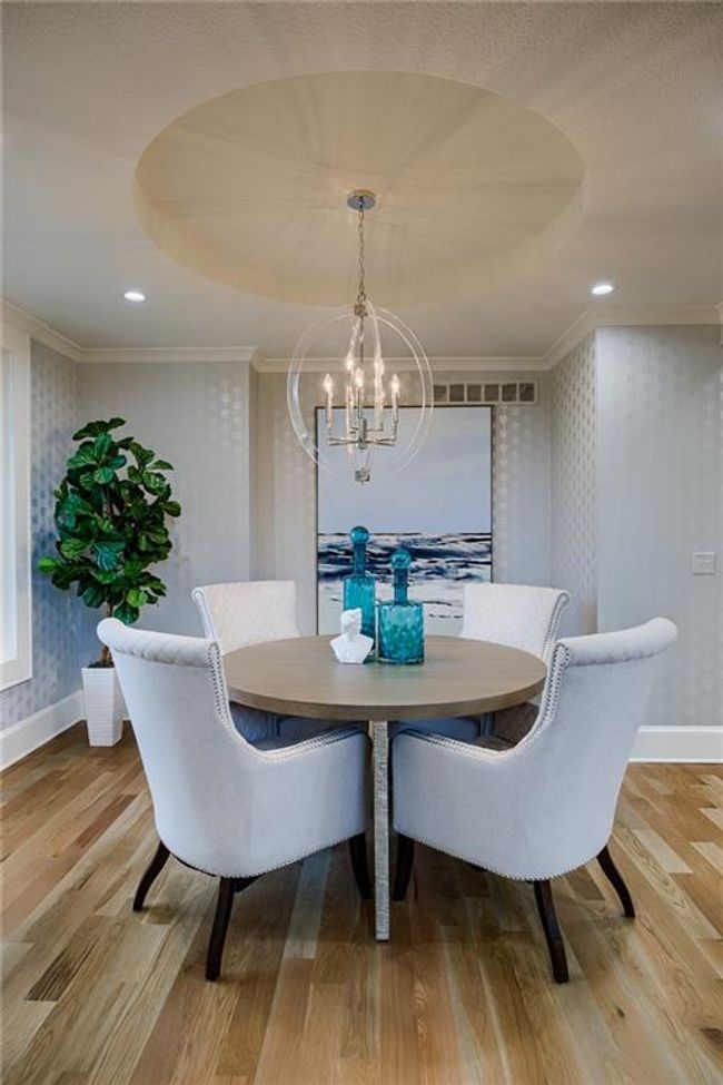 Dining space with light hardwood / wood-style flooring, an inviting chandelier, and ornamental molding | Image 22