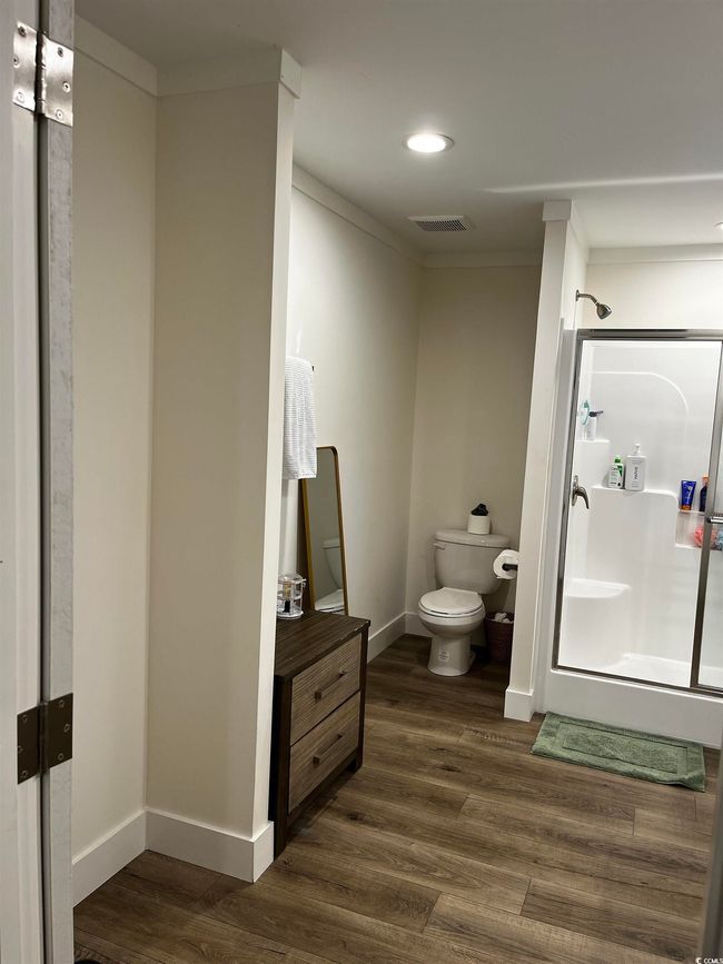 Full bath with wood finished floors, a stall shower, crown molding, recessed lighting, and vanity | Image 20