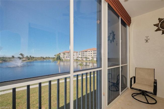 Unfurnished sunroom featuring a water view | Image 10