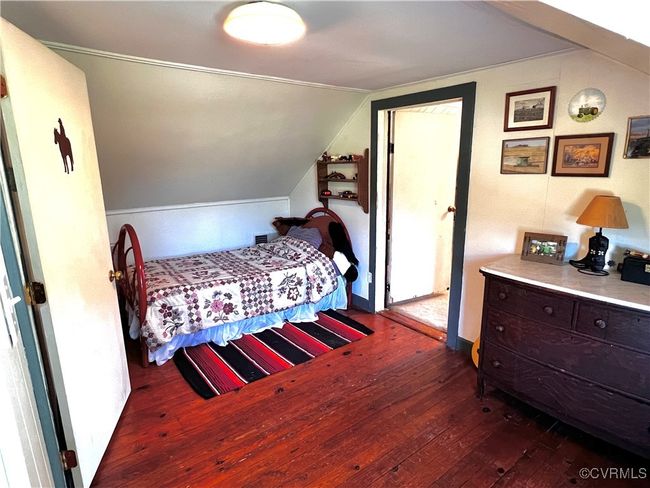 Bedroom featuring lofted ceiling and dark hardwood / wood-style flooring | Image 30