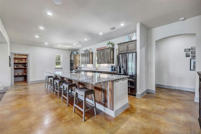 This home is bright and cheerful with under-cabinet lighting as well as recessed lighting. | Image 15
