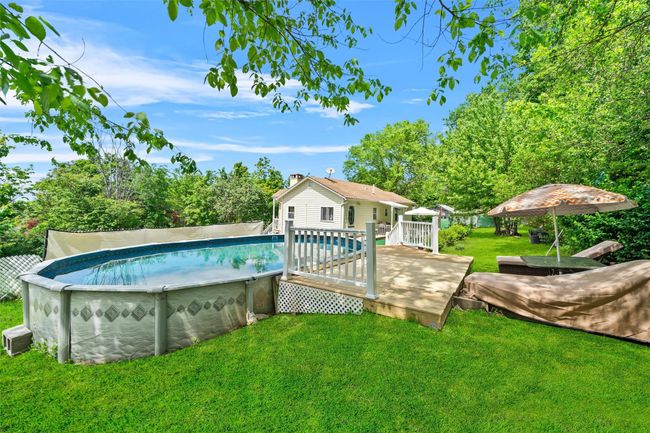 Outdoor pool featuring a wooden deck | Image 29