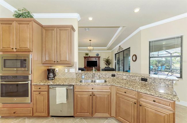 Honey-Glazed Maple Cabinetry, Stainless and Granite Counters | Image 29