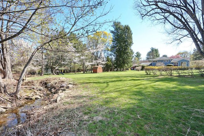 View of yard featuring an outdoor structure and a shed | Image 34