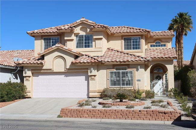 Mediterranean / spanish-style home featuring stucco siding, driveway, and a tile roof | Image 7