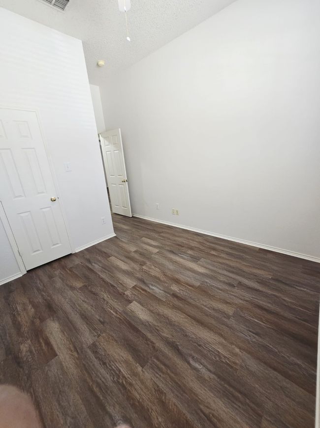 Unfurnished bedroom featuring dark wood finished floors and baseboards | Image 20