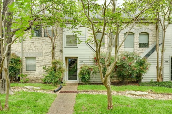 Townhome / multi-family property with a front yard and stone siding | Image 28
