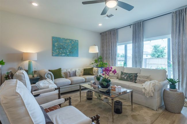 Living area with a ceiling fan, recessed lighting, and wood finished floors | Image 4