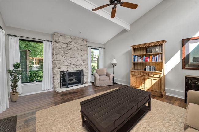 Living room features 2 brand new picture windows that showcase stunning views of the greenbelt and pool! Gas fireplace is hand painted river rock! | Image 8