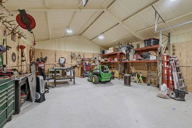 Garage with a workshop area | Image 24