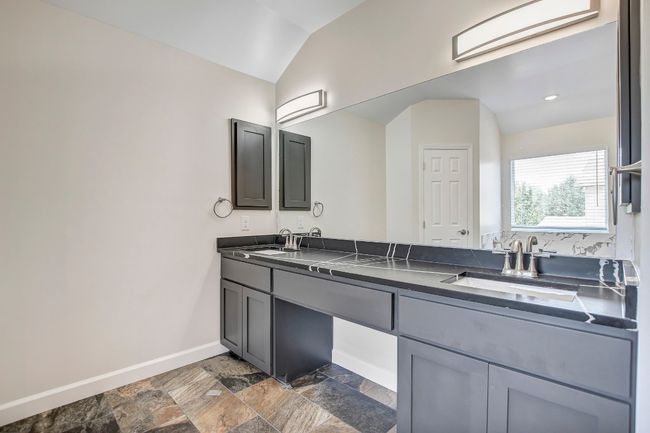 Bathroom featuring double vanity, stone tile flooring | Image 10