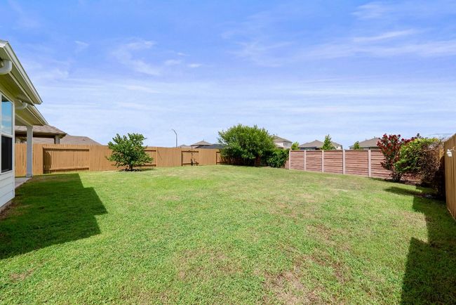 View of fenced backyard | Image 23