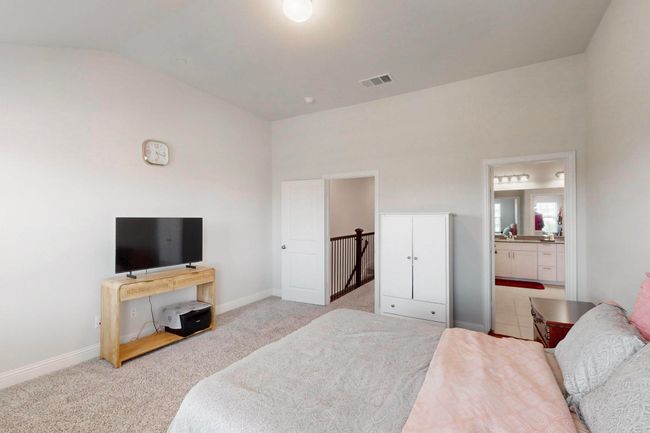 Bedroom with carpet floors, vaulted ceiling, and ensuite bathroom | Image 16