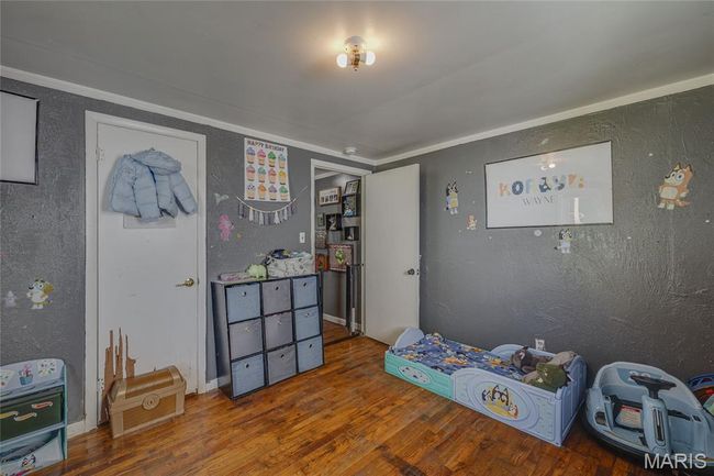 Game room featuring wood finished floors, crown molding, and a textured wall | Image 19