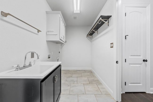 Washroom with electric dryer hookup, cabinet space, and washer hookup | Image 21