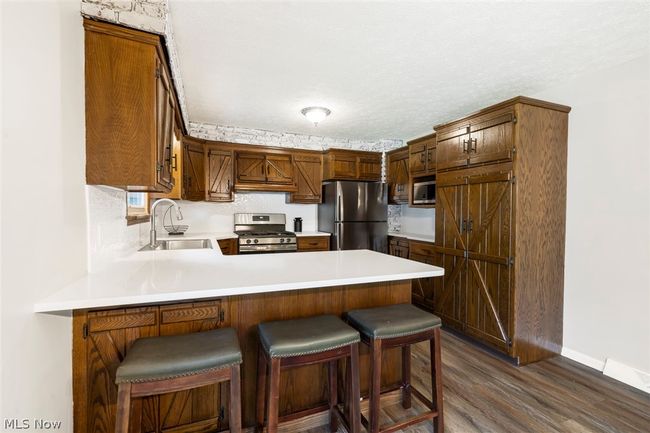 Kitchen with stainless steel fridge, pendant lighting, and hardwood / wood-style floors | Image 10