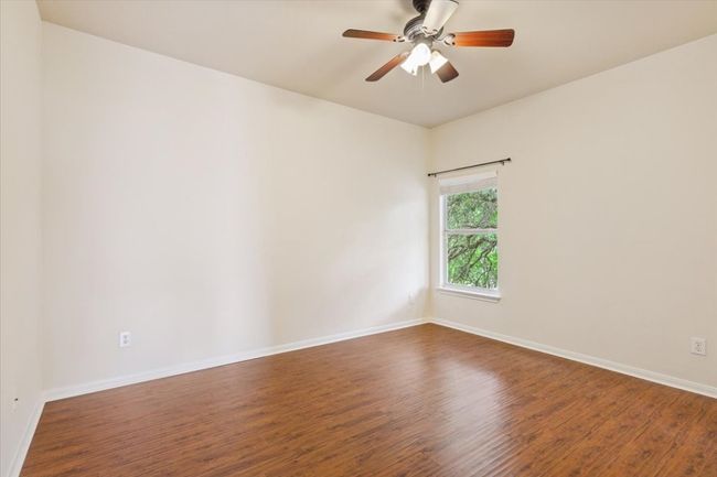 Empty room featuring wood finished floors and a ceiling fan | Image 33
