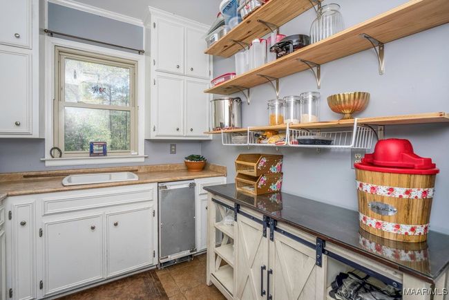 What a walk-in Pantry! Built-in icemaker and sink and tile floors | Image 36