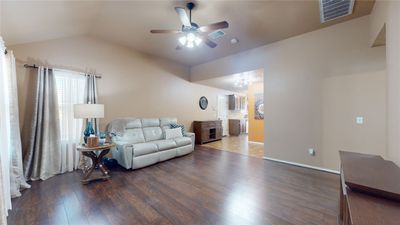 Living room featuring lofted ceiling, ceiling fan, and hardwood / wood-style flooring | Image 2