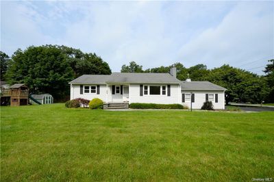 View of front of house with an outdoor structure and a front lawn | Image 1