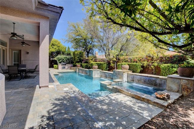 View of pool featuring outdoor dining area, ceiling fan, a pool with connected hot tub, and a patio area | Image 45