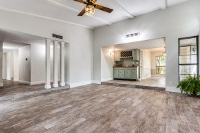 Unfurnished living room with beam ceiling, baseboards, and ceiling fan | Image 9