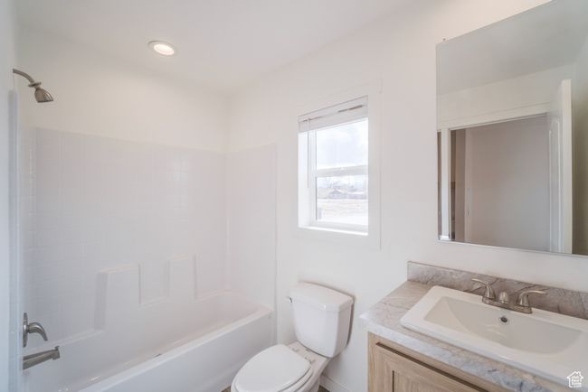 Bathroom featuring vanity, toilet, tub / shower combination, and recessed lighting | Image 17