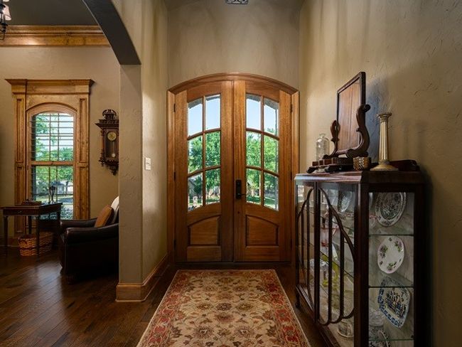 Entryway featuring arched walkways, baseboards, dark wood-style flooring, and french doors | Image 4