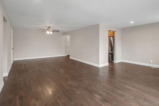Unfurnished room featuring recessed lighting, dark wood-style flooring, baseboards, and ceiling fan | Image 4